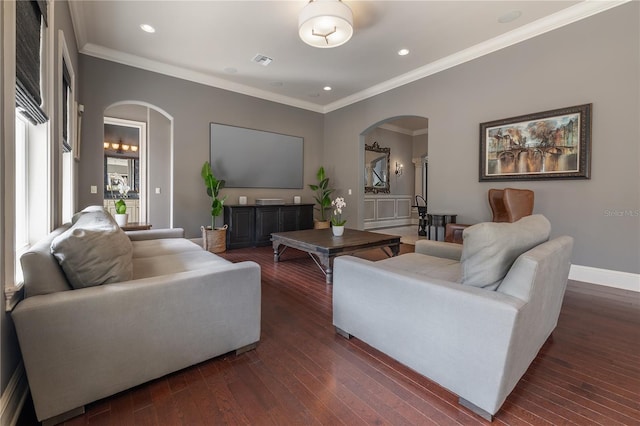 living room with dark wood-type flooring and crown molding