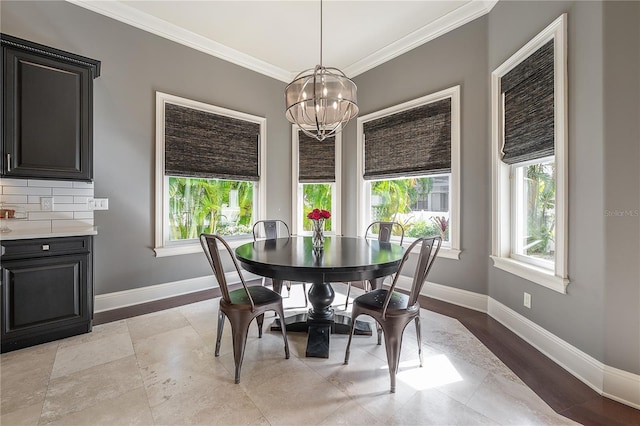 dining space with a chandelier and ornamental molding