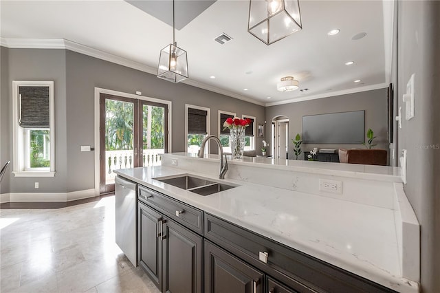 kitchen featuring stainless steel dishwasher, hanging light fixtures, sink, a wealth of natural light, and light stone counters