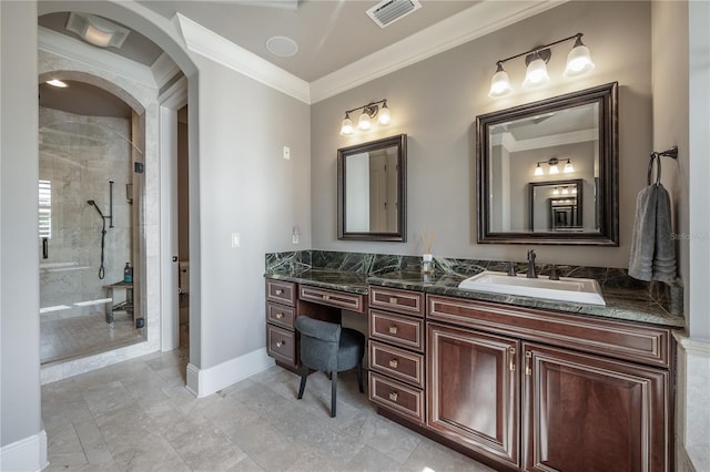 bathroom featuring a tile shower, vanity, and ornamental molding