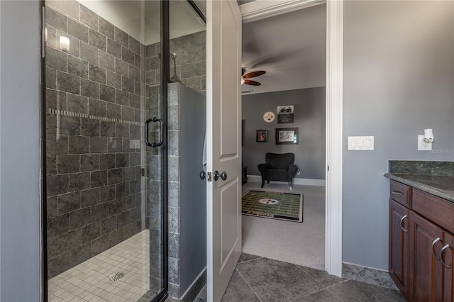 bathroom featuring ceiling fan, tile patterned floors, vanity, and walk in shower