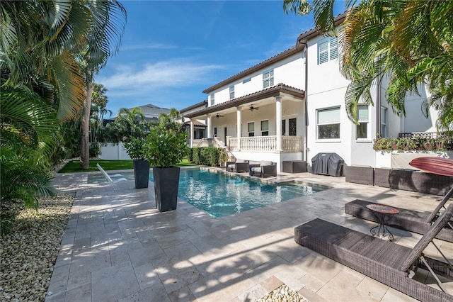 view of pool with a patio, grilling area, and ceiling fan