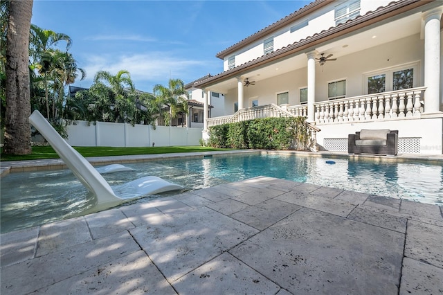 view of swimming pool featuring ceiling fan and a patio area