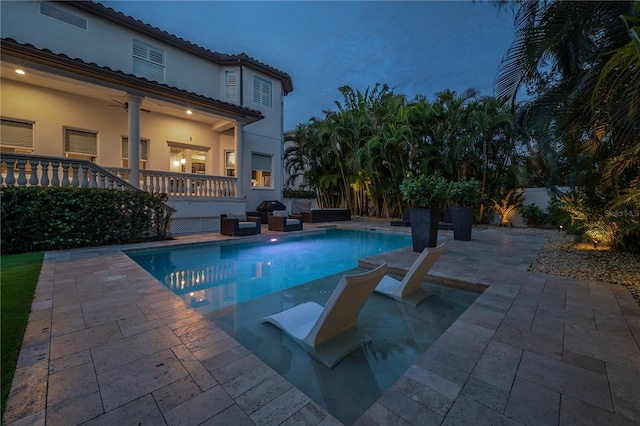 view of pool featuring a patio and ceiling fan