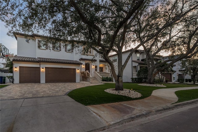 view of front of house with a yard and a garage