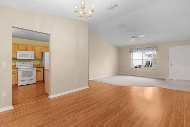 unfurnished living room featuring lofted ceiling, ceiling fan with notable chandelier, a textured ceiling, and light hardwood / wood-style floors