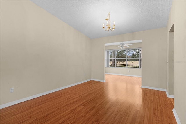 interior space with ceiling fan with notable chandelier, light hardwood / wood-style floors, and a textured ceiling