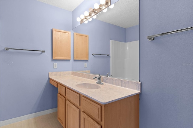 bathroom featuring vanity and a textured ceiling