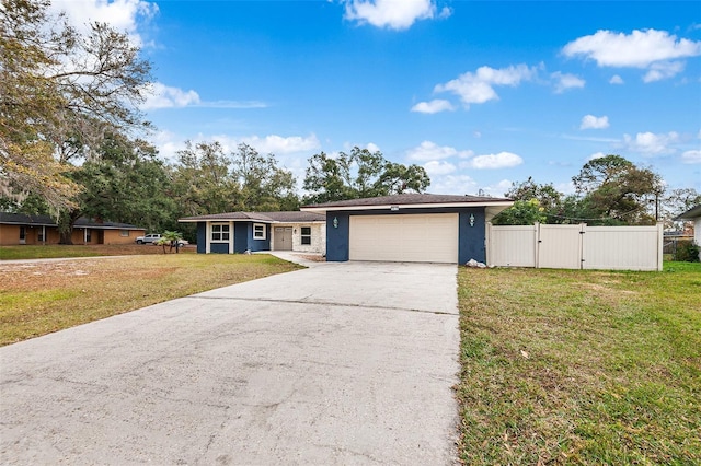 ranch-style home with a garage and a front yard