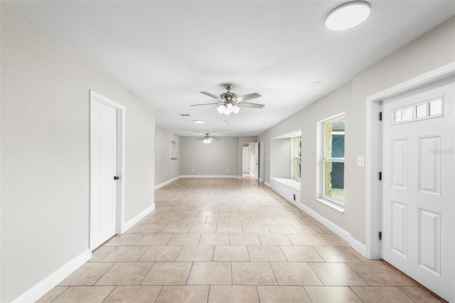 tiled spare room featuring ceiling fan