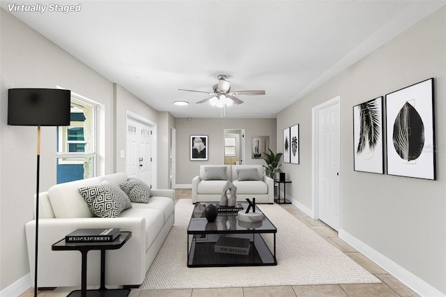 tiled living room featuring ceiling fan