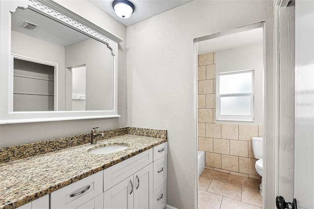 full bathroom featuring tile patterned floors, toilet, shower / washtub combination, and vanity