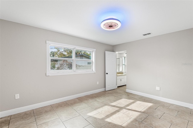 spare room featuring light tile patterned floors