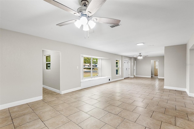 unfurnished room with light tile patterned floors and ceiling fan