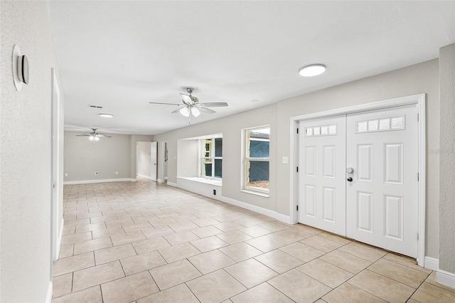 entrance foyer featuring light tile patterned floors and ceiling fan