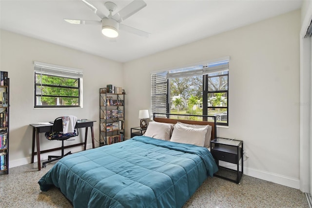 bedroom with ceiling fan and multiple windows