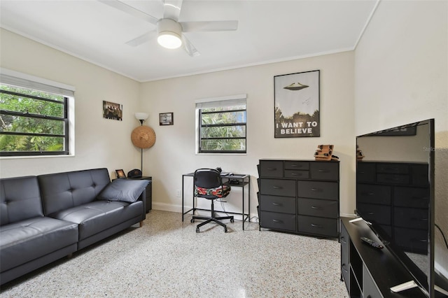 home office with ceiling fan, a wealth of natural light, and crown molding