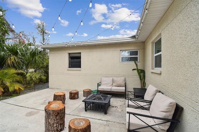 view of patio / terrace featuring an outdoor living space with a fire pit