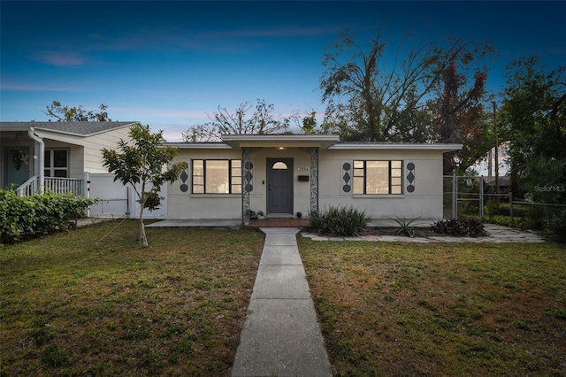 view of front of property with a lawn