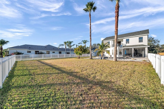 back of house with a patio, a lawn, a fenced backyard, and a balcony