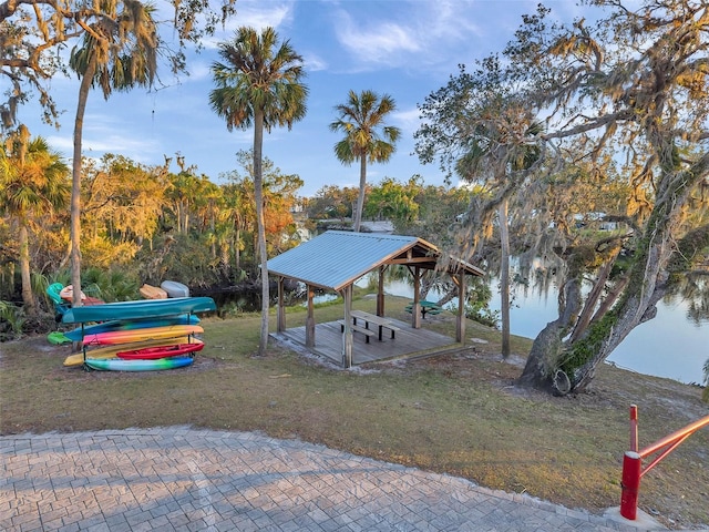 dock area featuring a gazebo, a yard, and a water view