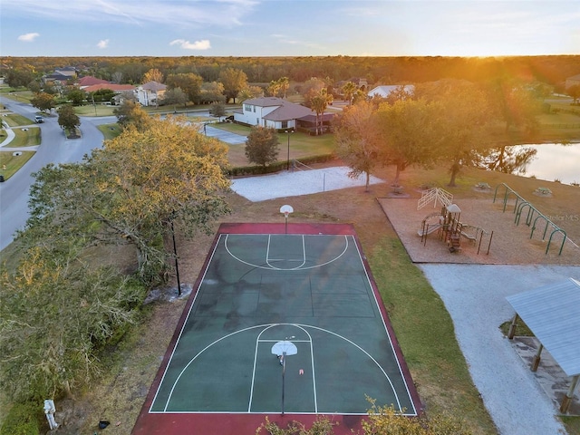 view of sport court with community basketball court and a water view