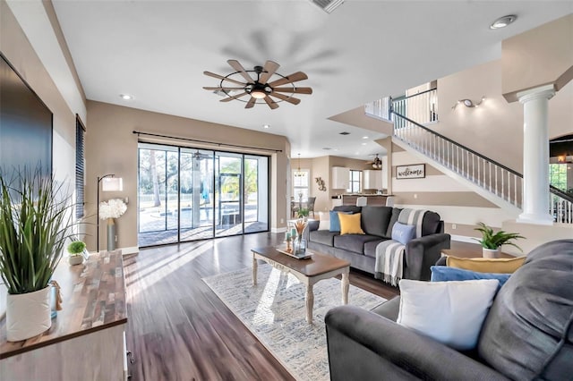 living area with ceiling fan, recessed lighting, wood finished floors, baseboards, and decorative columns