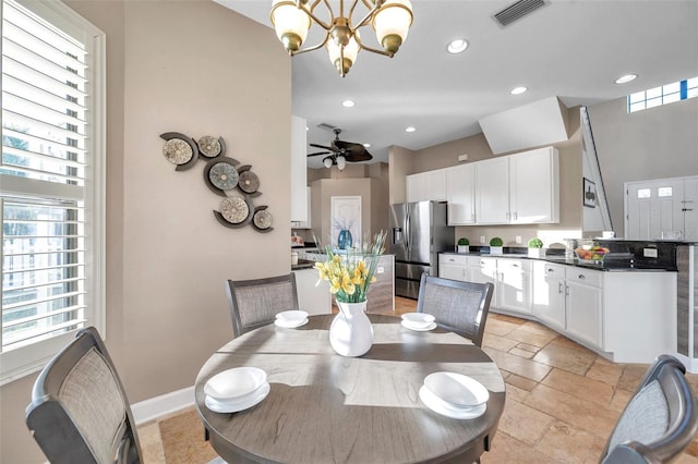 dining room featuring stone tile floors, recessed lighting, baseboards, visible vents, and ceiling fan with notable chandelier