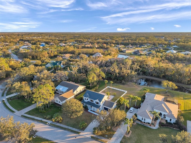 drone / aerial view featuring a water view and a residential view