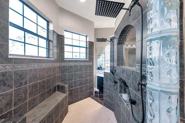 full bathroom with tile patterned floors, tile walls, and a walk in shower