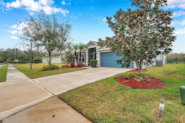 view of front of house with a garage, central AC unit, and a front yard