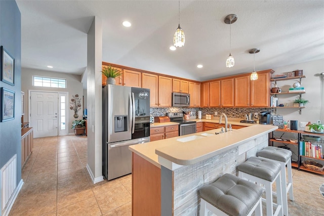 kitchen with tasteful backsplash, light tile patterned floors, stainless steel appliances, and a kitchen bar