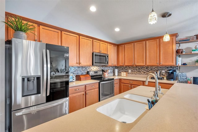 kitchen with stainless steel appliances, hanging light fixtures, sink, and backsplash