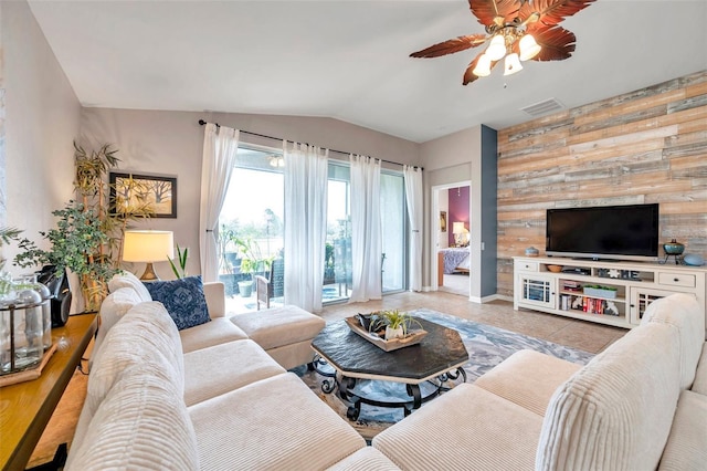 tiled living room with lofted ceiling and ceiling fan