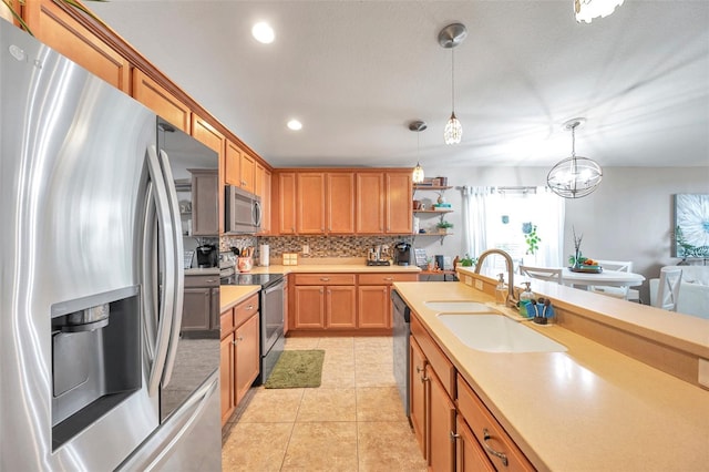 5720 107th Ter E, Parrish, FL 34219 - kitchen with appliances with stainless steel finishes, open shelves, light countertops, backsplash, and hanging light fixtures