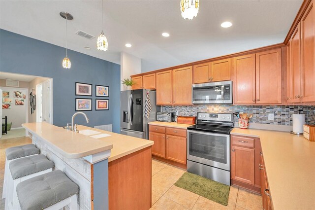 5720 107th Ter E, Parrish, FL 34219 - kitchen featuring stainless steel appliances, backsplash, light countertops, decorative light fixtures, and recessed lighting