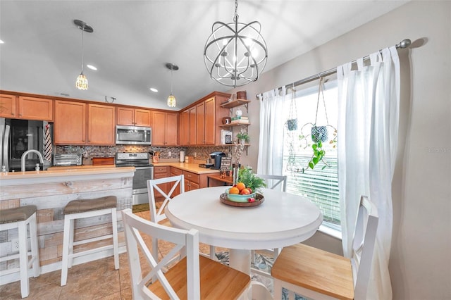5720 107th Ter E, Parrish, FL 34219 - kitchen featuring stainless steel appliances, tasteful backsplash, open shelves, light countertops, and hanging light fixtures