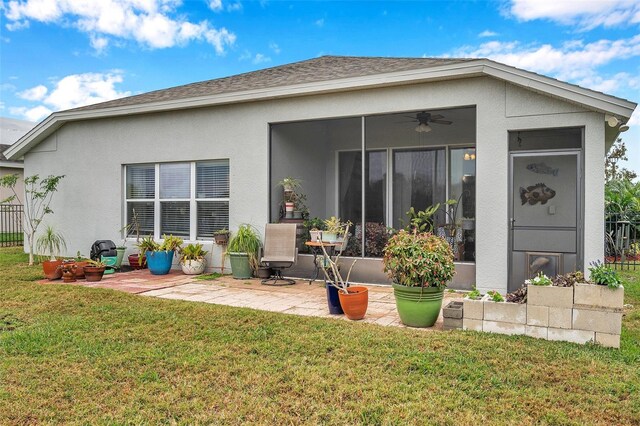 5720 107th Ter E, Parrish, FL 34219 - back of property featuring a yard, a sunroom, a ceiling fan, a patio, and stucco siding