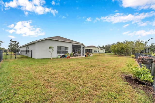 5720 107th Ter E, Parrish, FL 34219 - rear view of property featuring stucco siding and a fenced backyard
