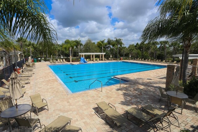 5720 107th Ter E, Parrish, FL 34219 - community pool featuring a patio area and view of scattered trees