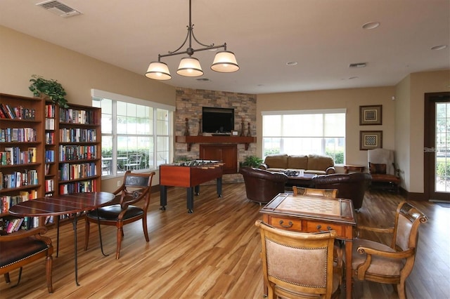5720 107th Ter E, Parrish, FL 34219 - dining room featuring light wood-type flooring, healthy amount of natural light, a fireplace, and recessed lighting
