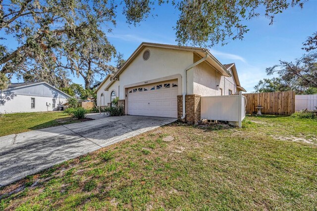 view of front of home with a garage and a front lawn