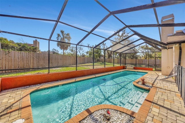 view of swimming pool with a patio and glass enclosure