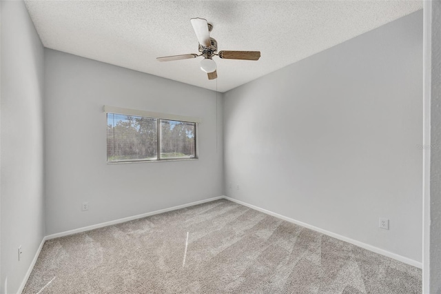 carpeted spare room featuring ceiling fan and a textured ceiling