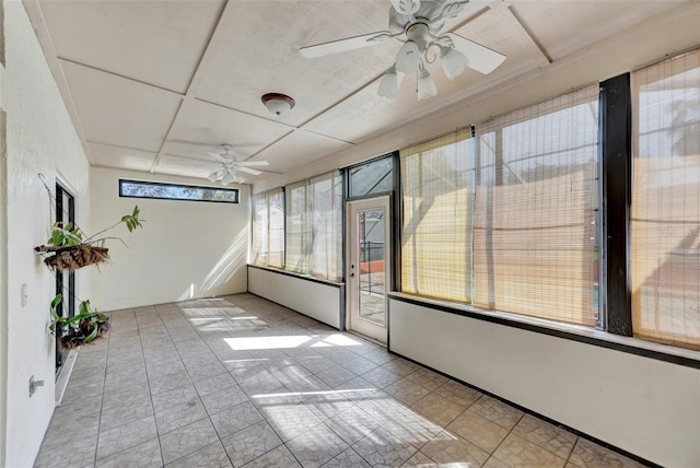 unfurnished sunroom with ceiling fan