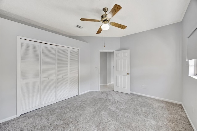 unfurnished bedroom with light carpet, a closet, and ceiling fan