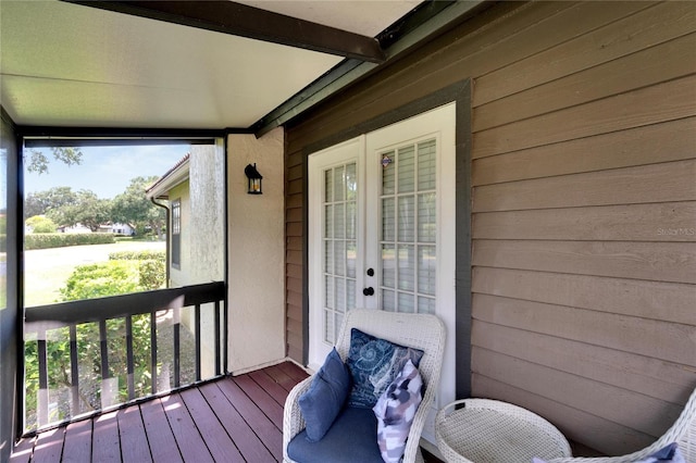 exterior space with beam ceiling and french doors