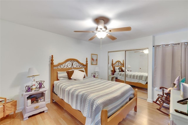 bedroom featuring light hardwood / wood-style floors, ceiling fan, and a closet