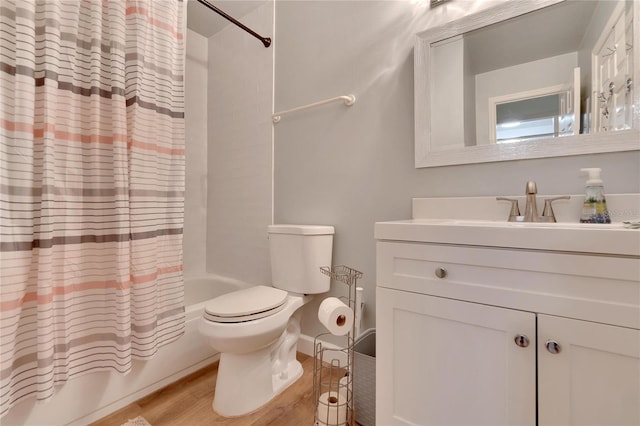 full bathroom with vanity, hardwood / wood-style flooring, toilet, and shower / bath combo with shower curtain