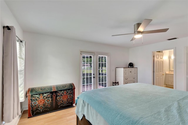 bedroom featuring ensuite bath, ceiling fan, access to outside, french doors, and light wood-type flooring